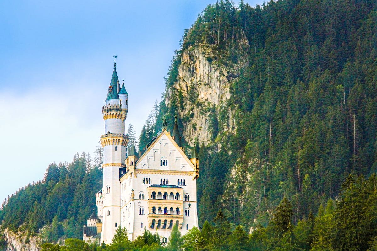 Castle Neuschwanstein with landscape of trees and a mountain