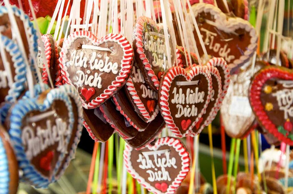 Heart-shaped gingerbread cookies (Lebkuchenherzen) decorated with icing reading “Ich liebe Dich,” in German language, meaning I love you, a sweet Oktoberfest souvenir.